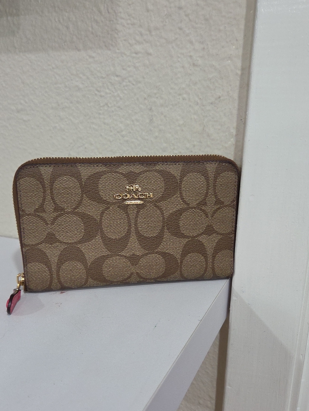 Coach Signature Zip Wallet in Khaki/Tan with Colorful Stripes Inside.
